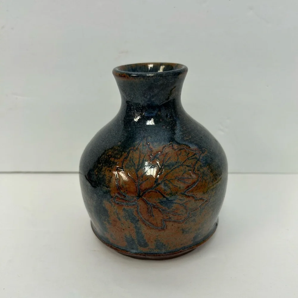Handmade art pottery vase with a glossy glaze blend of blue and brown/ signed